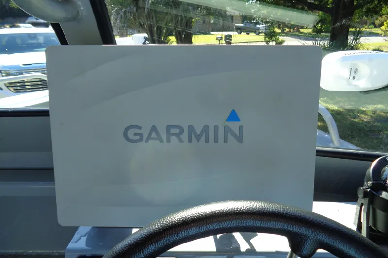 Slide: The Image of Garmin device inside 2022 Hewes 210 Searunner ET Hardtop boat cockpit. - 11