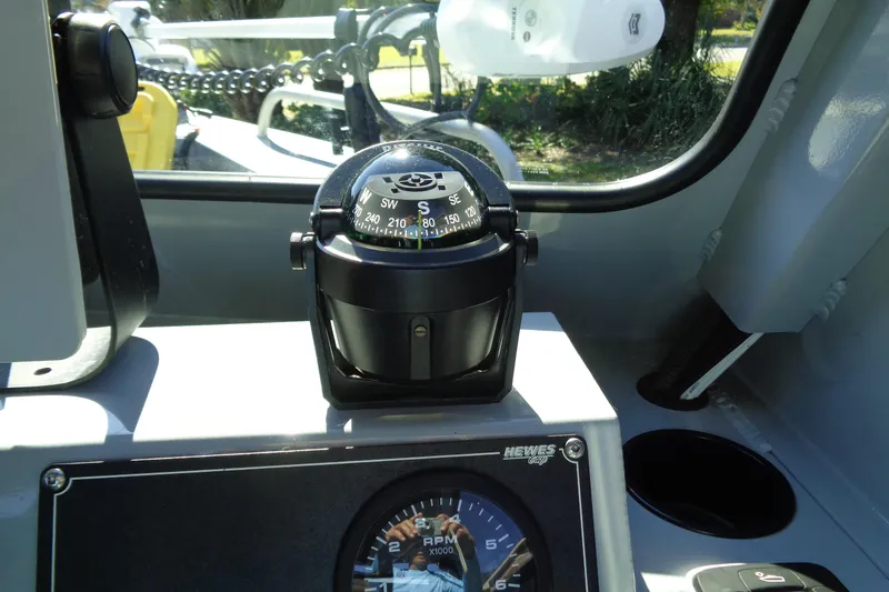 Slide: The Image of Compass and RPM gauge inside 2022 Hewes 210 Searunner ET Hardtop boat. - 14
