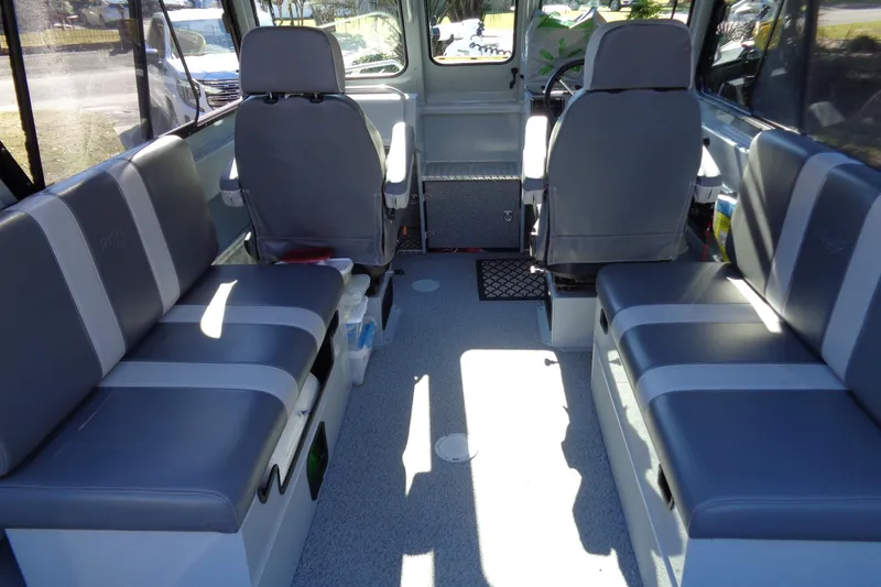 Slide: The Image of Interior of 2022 Hewes 210 Searunner ET Hardtop boat with gray seating. - 23