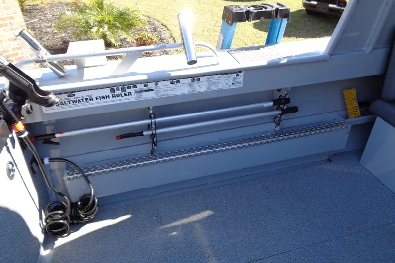 Slide: The Image of 2022 Hewes 210 Searunner ET Hardtop interior with saltwater fish ruler and fishing gear. - 28