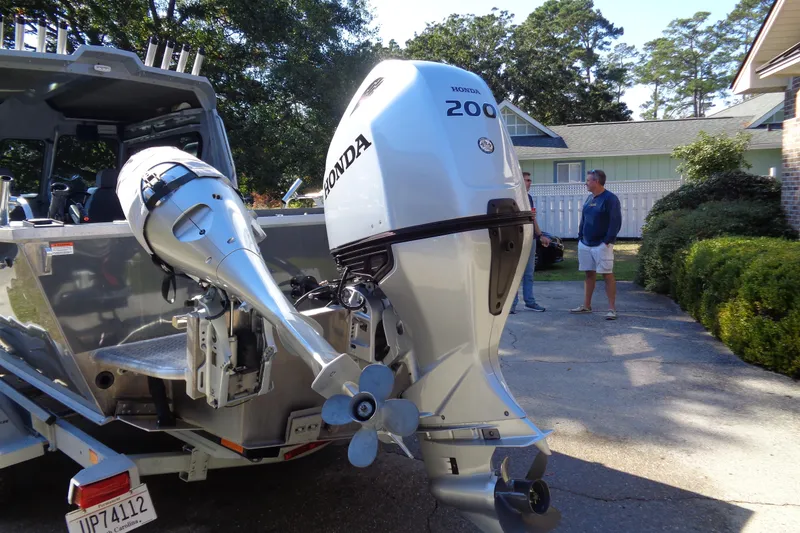 Slide: The Image of 2022 Hewes 210 Searunner ET Hartop with Honda outboard motors in driveway. - 4