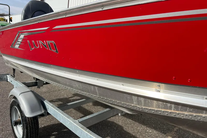 Slide: The Image of 2023 Lund SSV-14 Tiller trailer wheel on asphalt surface. - 13