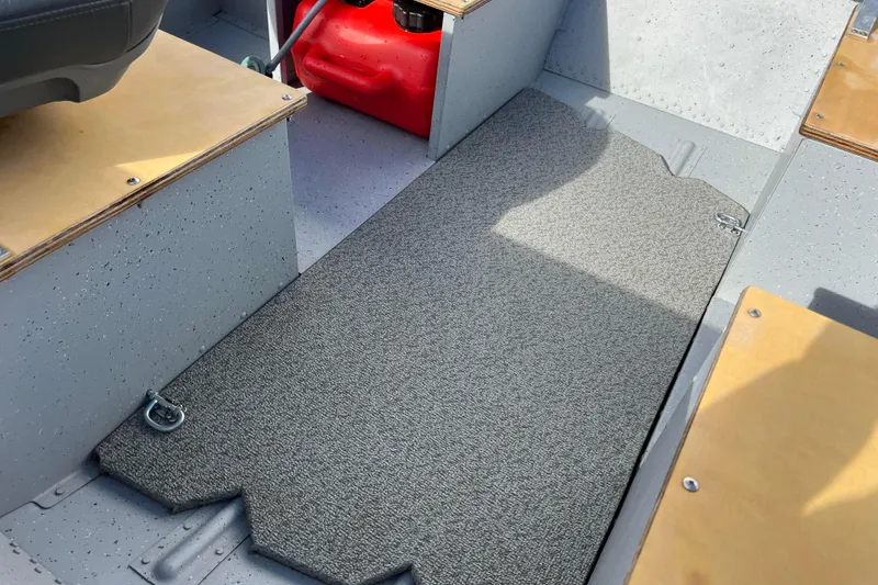 Slide: The Image of 2023 Lund SSV-14 Tiller boat interior with wooden seats and carpeted floor. - 21