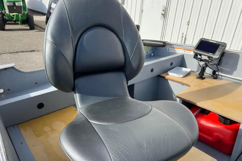 Slide: The Image of 2023 Lund SSV-14 Tiller boat interior with carpeted floor and storage compartments. - 22