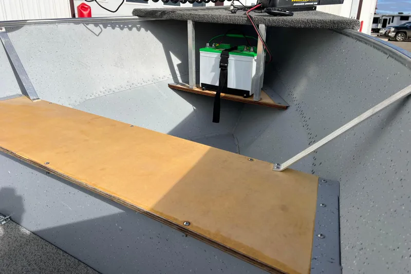 Slide: The Image of 2023 Lund SSV-14 Tiller boat with trolling motor, seats, and wooden benches. - 31