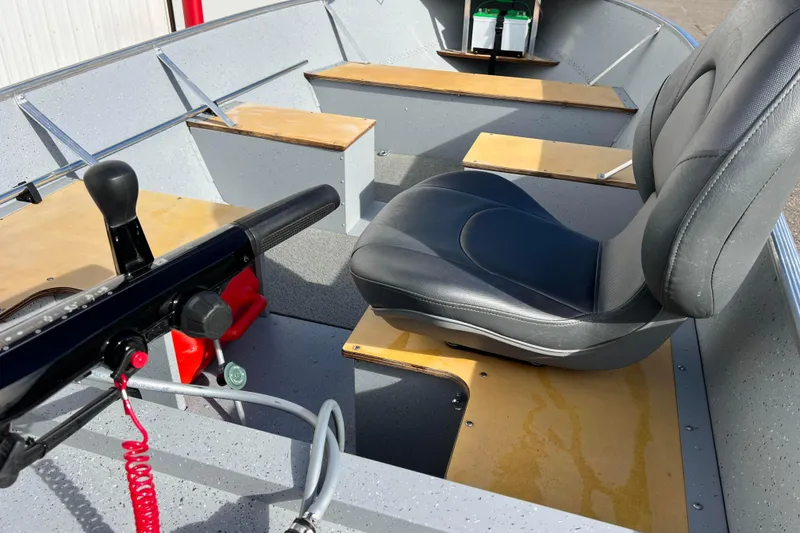Slide: The Image of 2023 Lund SSV-14 Tiller boat interior with wooden seats and battery compartment. - 33