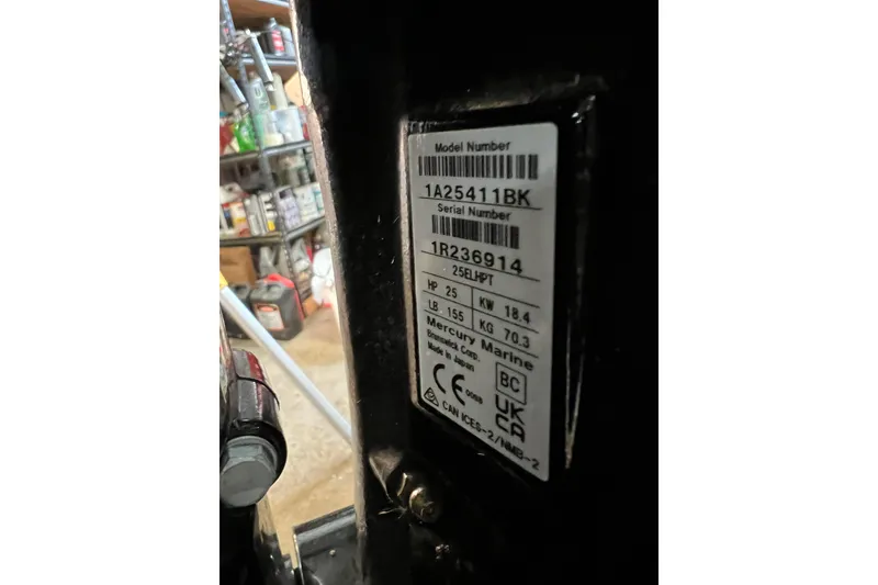 Slide: The Image of 2023 Lund SSV-14 Tiller boat on trailer, red and silver design, parked outdoors. - 39