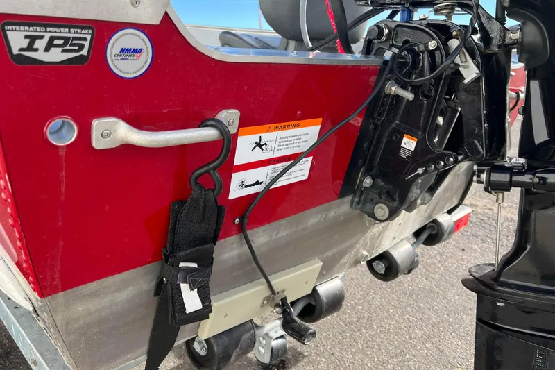 Slide: The Image of Close-up of 2023 Lund SSV-14 Tiller boat with red exterior and yellow tool. - 9