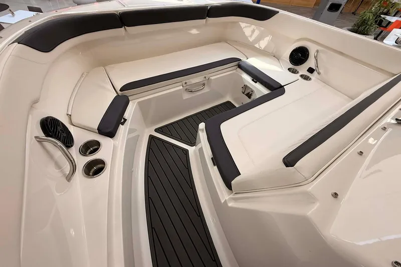 Slide: The Image of 2026 Bayliner Trophy T22SC boat interior with cushioned seating and cup holders. - 10