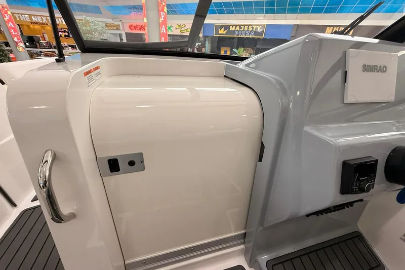 Slide: The Image of 2026 Bayliner Trophy T22SC boat interior with Simrad electronics and sleek design. - 12