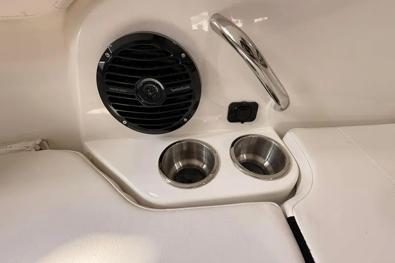 Slide: The Image of 2026 Bayliner Trophy T22SC interior with speaker, cup holders, and handrail. - 15