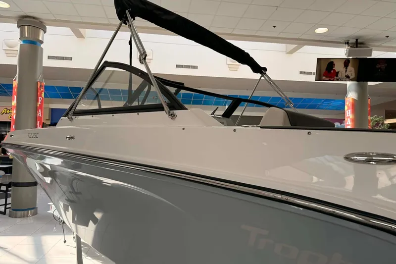 Slide: The Image of 2026 Bayliner Trophy T22SC boat displayed indoors, showcasing sleek design and modern features. - 2