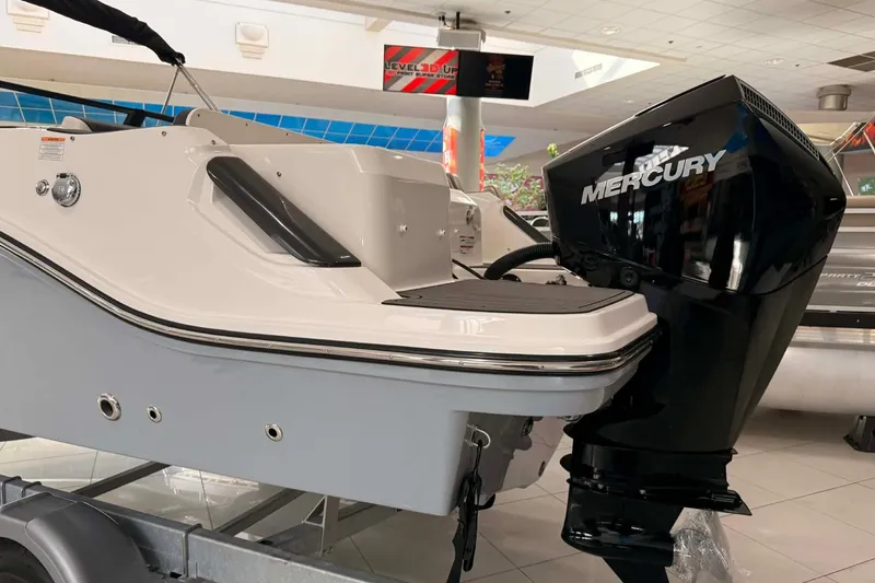 Slide: The Image of 2026 Bayliner Trophy T22SC boat with Mercury outboard motor in showroom. - 20