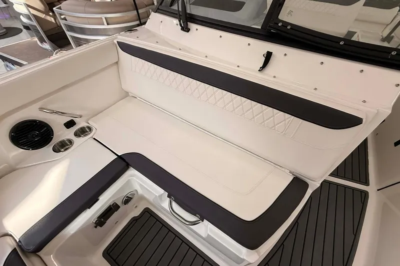 Slide: The Image of 2026 Bayliner Trophy T22SC boat interior with cushioned seating and cup holders. - 5
