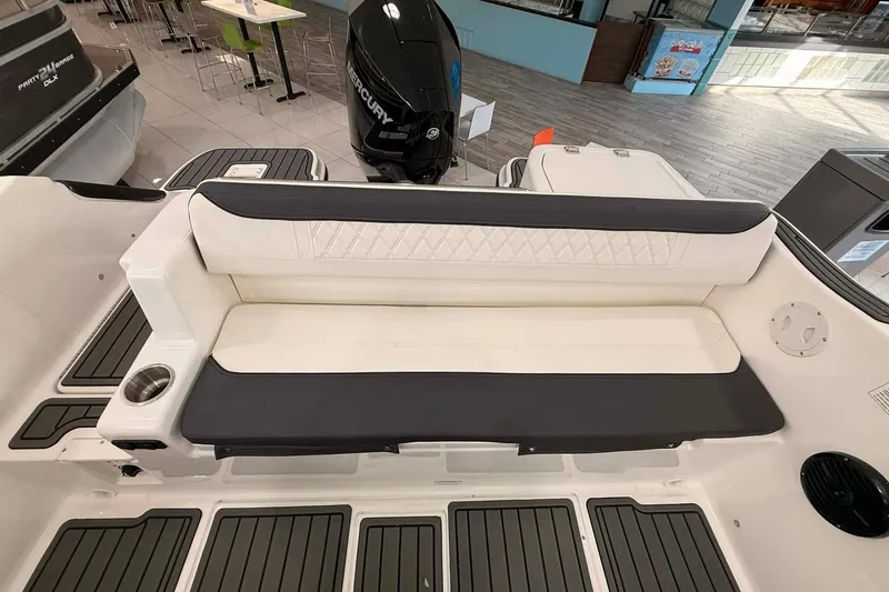 Slide: The Image of 2026 Bayliner Trophy T22SC boat interior with cushioned seating and cup holder. - 6