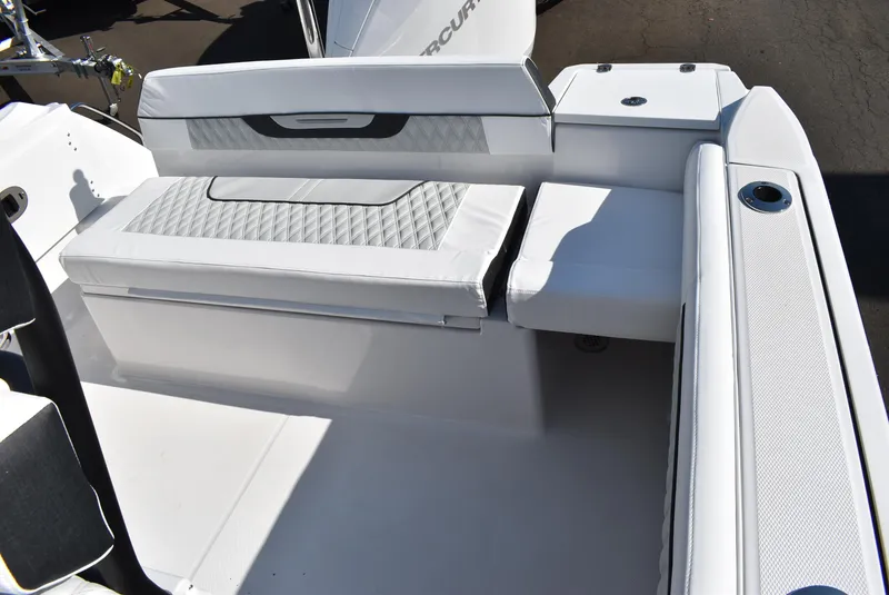 Slide: The Image of 2025 Blackfin 222CC boat interior with white cushioned seating and storage compartments. - 13