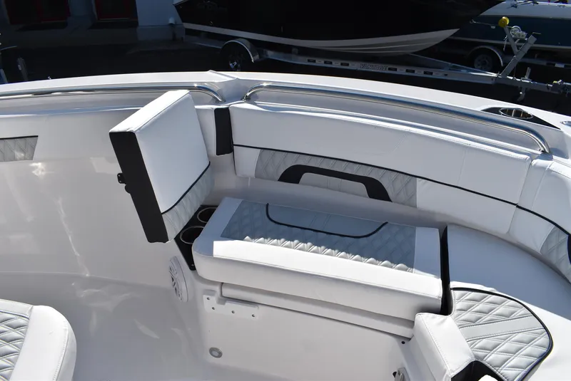 Slide: The Image of 2025 Blackfin 222CC boat interior with white cushioned seating and sleek design. - 16
