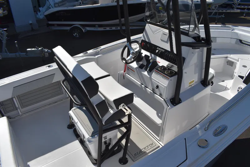 Slide: The Image of 2025 Blackfin 222CC boat interior with steering console and seating. - 8