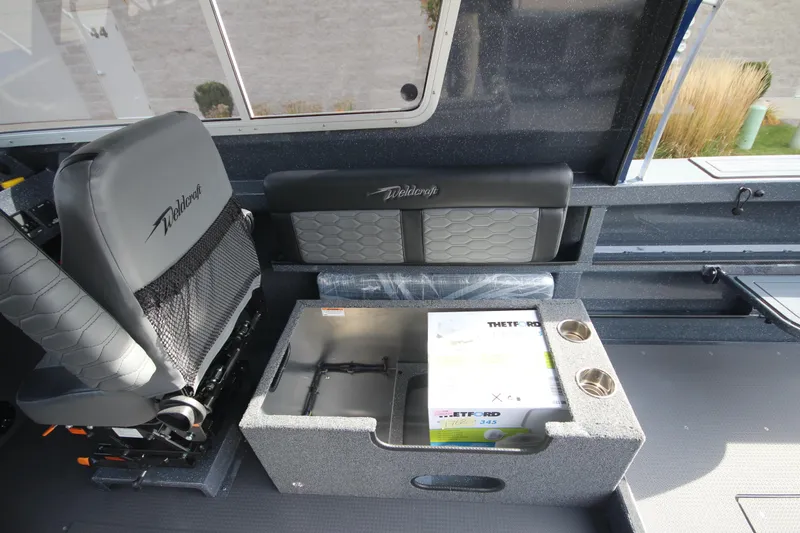 Slide: The Image of Interior of 2026 Weldcraft 260 Ocean King boat, featuring modern helm and seating. - 23