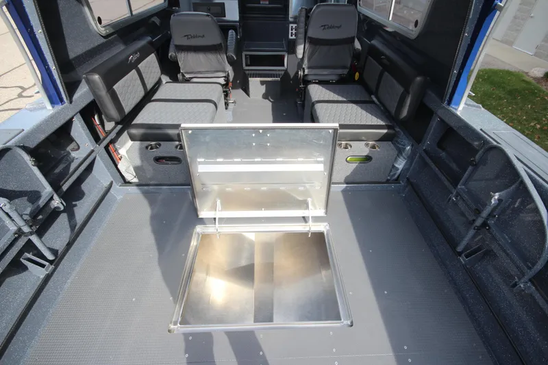 Slide: The Image of Interior of 2026 Weldcraft 260 Ocean King boat, featuring modern seating and navigation equipment. - 17