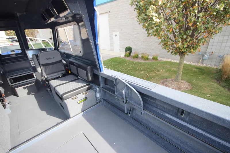 Slide: The Image of Interior of 2026 Weldcraft 260 Ocean King boat, featuring modern seating and navigation equipment. - 18