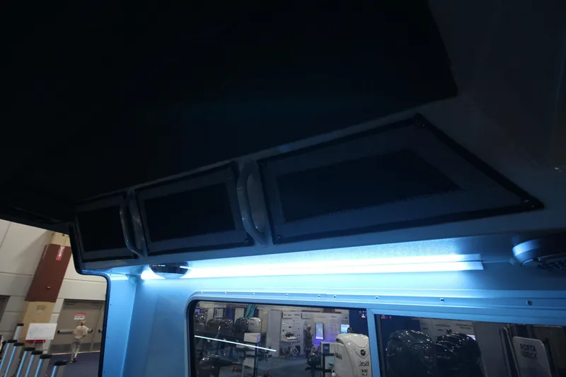 Slide: The Image of Interior view of 2026 Weldcraft 260 Ocean King boat with overhead compartments. - 49