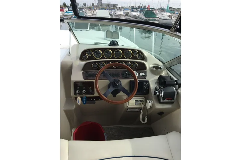 Slide: The Image of 2001 Rinker 310 Fiesta Vee boat dashboard with steering wheel and control panel. - 3