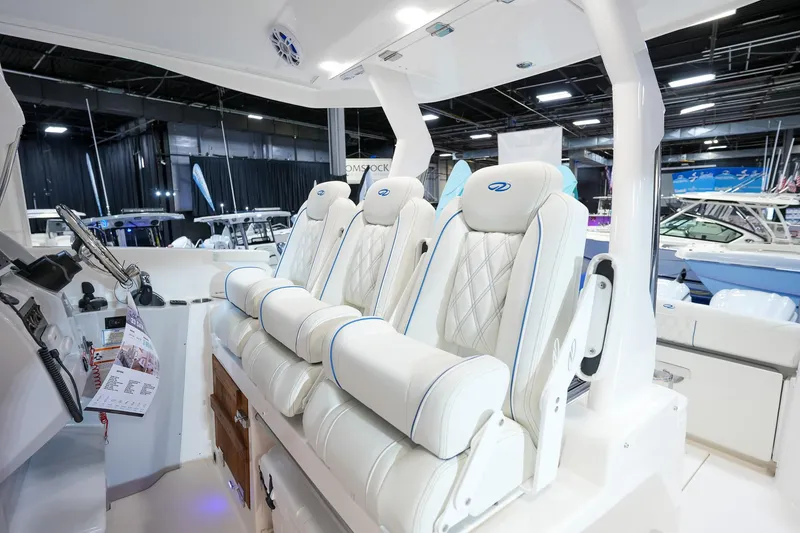 Slide: The Image of Luxurious interior seating of 2025 Regal 33 SAV boat, featuring plush white upholstery. - 11