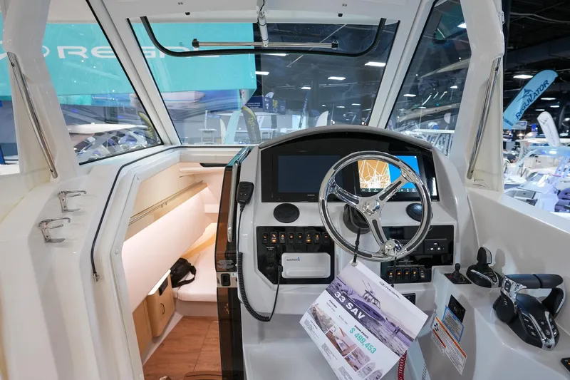 Slide: The Image of 2025 Regal 33 SAV boat interior with modern dashboard and steering wheel. - 12