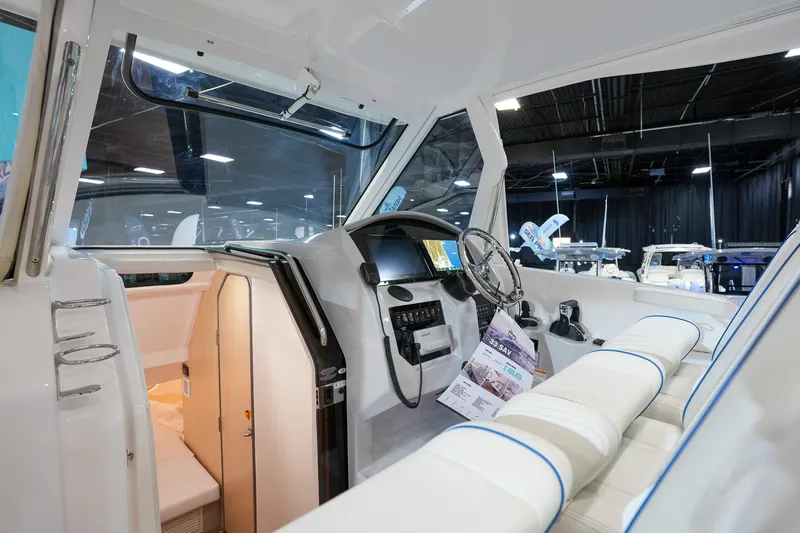 Slide: The Image of Interior of 2025 Regal 33 SAV boat, showcasing modern helm and seating. - 13