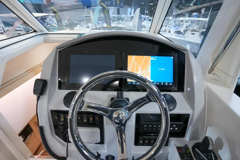 Slide: The Image of 2025 Regal 33 SAV boat dashboard with modern navigation displays and controls. - 14