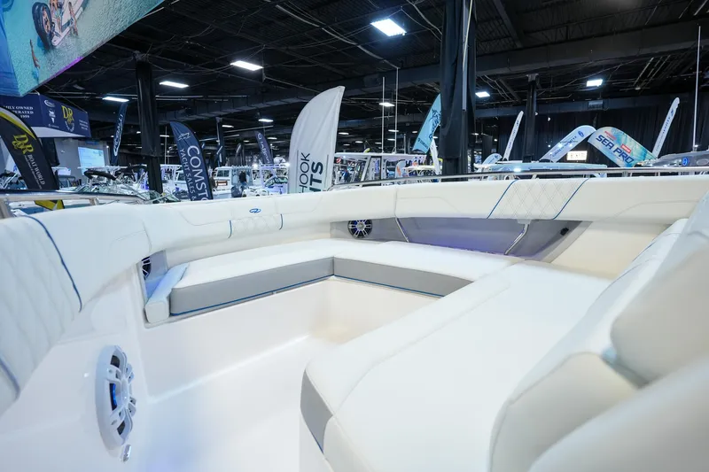 Slide: The Image of 2025 Regal 33 SAV boat interior at a showroom, featuring sleek white seating. - 17