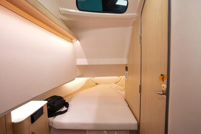 Slide: The Image of 2025 Regal 33 SAV cabin interior with modern design and comfortable bedding. - 19