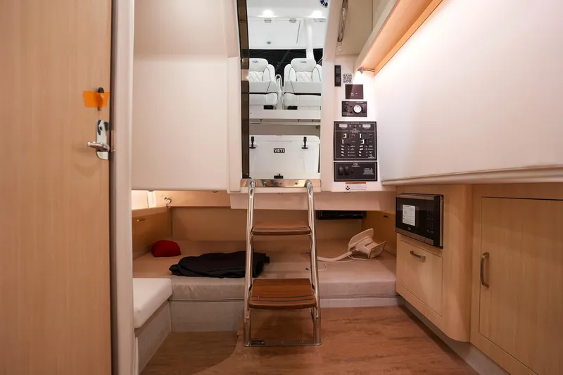 Slide: The Image of Interior of 2025 Regal 33 SAV boat, featuring modern design and wooden finishes. - 22