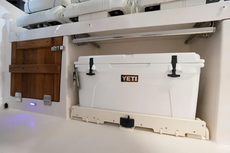 Slide: The Image of YETI cooler in 2025 Regal 33 SAV boat interior storage compartment. - 24