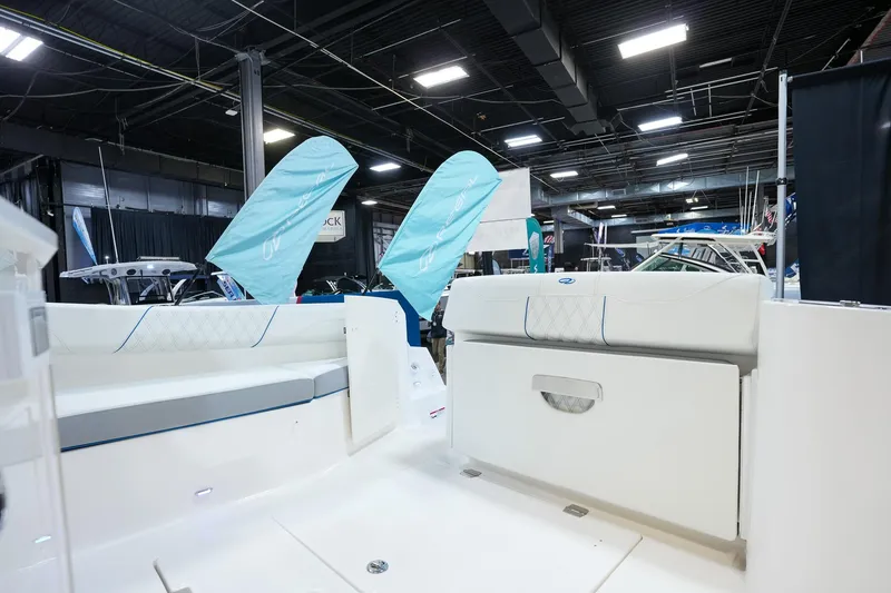 Slide: The Image of 2025 Regal 33 SAV boat interior at an indoor exhibition, showcasing seating and design. - 8