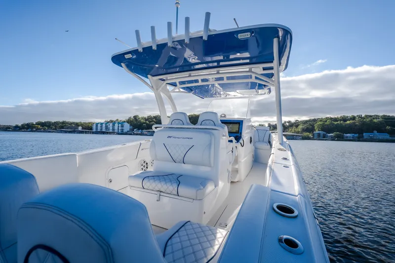 Slide: The Image of 2017 Midnight Express 39S Cuddy boat on calm water, featuring sleek design and luxurious seating. - 15