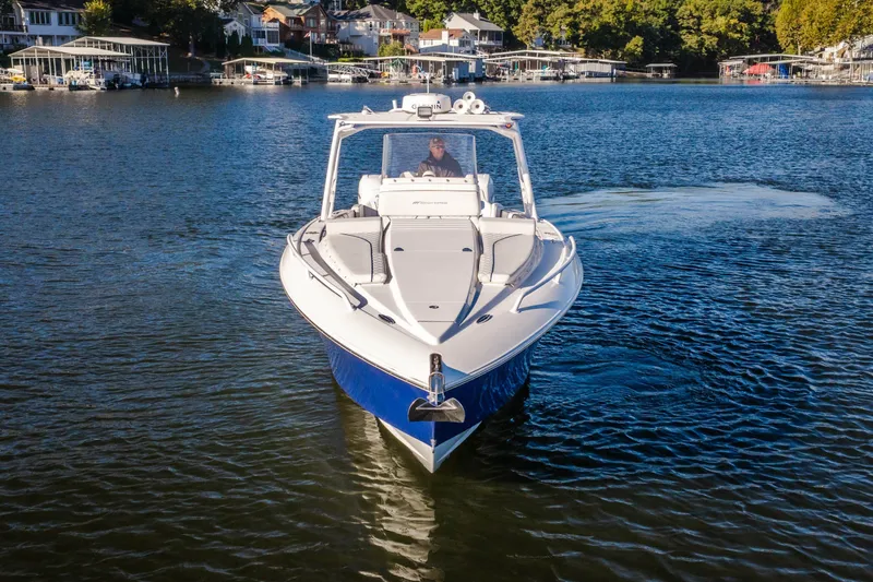 Slide: The Image of 2017 Midnight Express 39S Cuddy cruising on a serene lake with waterfront homes. - 4