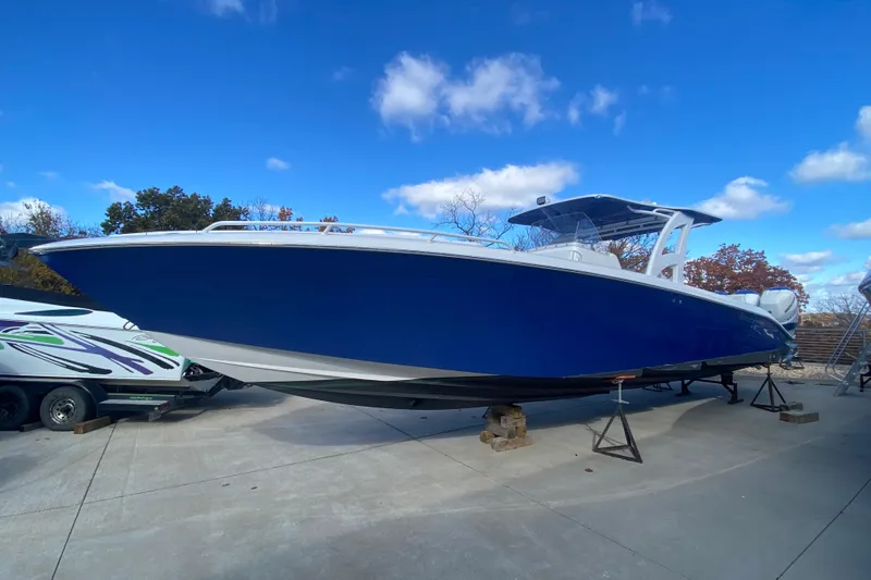 The Image of 2017 Midnight Express 39S Cuddy boat with blue hull on display outdoors. - 1