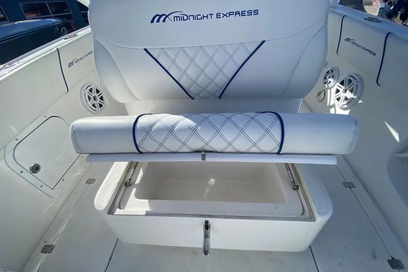 Slide: The Image of 2017 Midnight Express 39S Cuddy boat interior with cushioned seating and storage compartment. - 11