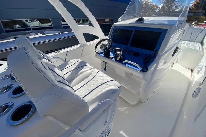 Slide: The Image of 2017 Midnight Express 39S Cuddy boat interior with modern helm and seating. - 12