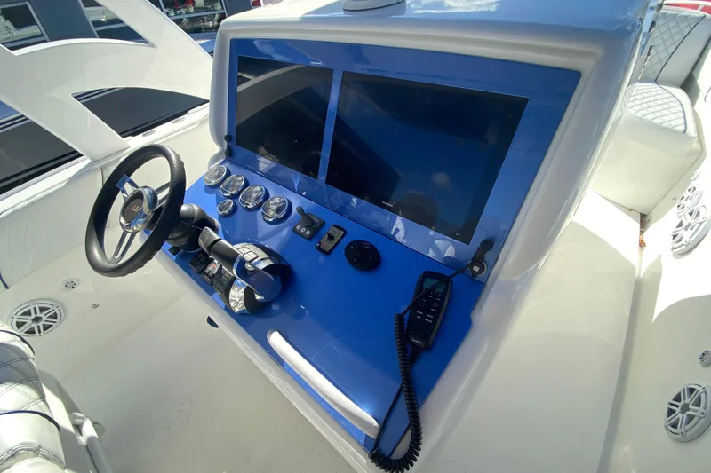 Slide: The Image of 2017 Midnight Express 39S Cuddy boat dashboard with dual screens and controls. - 13