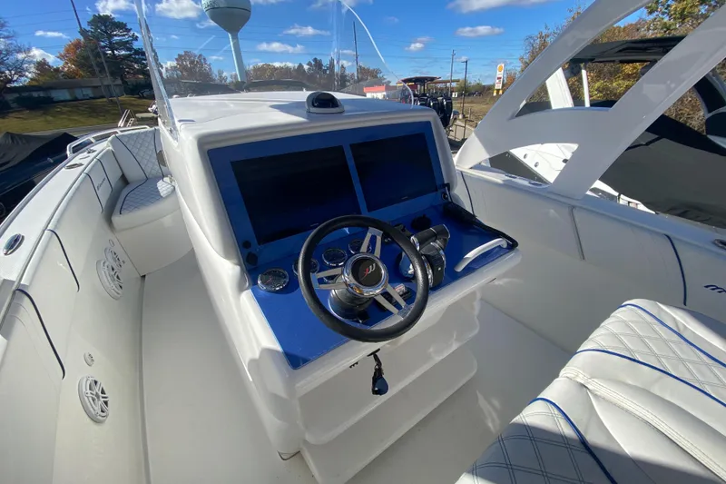 Slide: The Image of 2017 Midnight Express 39S Cuddy boat cockpit with steering wheel and navigation screens. - 15