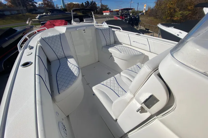 Slide: The Image of 2017 Midnight Express 39S Cuddy boat interior with white cushioned seating. - 16