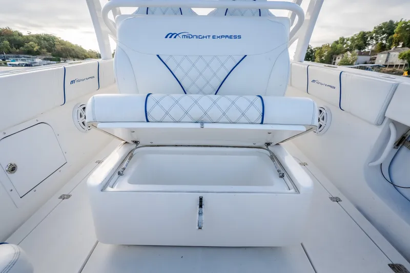 Slide: The Image of 2017 Midnight Express 39S Cuddy boat interior with open storage compartment and cushioned seating. - 17