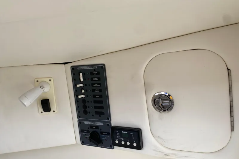 Slide: The Image of Control panel and storage compartment on a 2017 Midnight Express 39S Cuddy boat. - 24