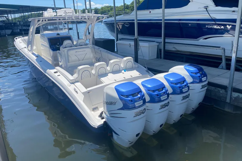Slide: The Image of 2017 Midnight Express 39S Cuddy boat with four Mercury 350 engines docked in marina. - 25