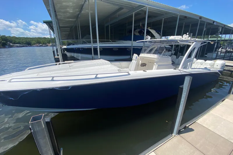 Slide: The Image of 2017 Midnight Express 39S Cuddy boat docked, featuring sleek design and spacious seating. - 26