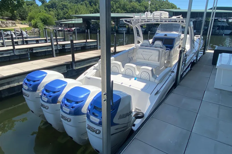 Slide: The Image of 2017 Midnight Express 39S Cuddy boat docked, featuring four powerful Mercury 350 engines. - 27