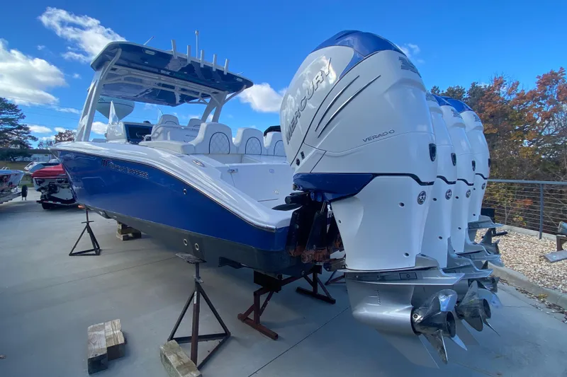 Slide: The Image of 2017 Midnight Express 39S Cuddy boat with four Mercury Verado engines, displayed outdoors. - 3